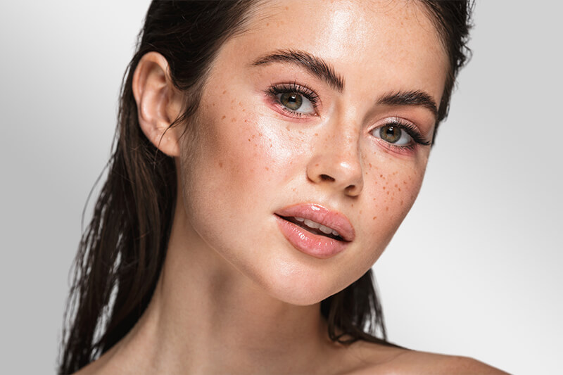 A woman showing her flawless skin from facial treatments at Oyster Bay, NY. [8fe6a4]