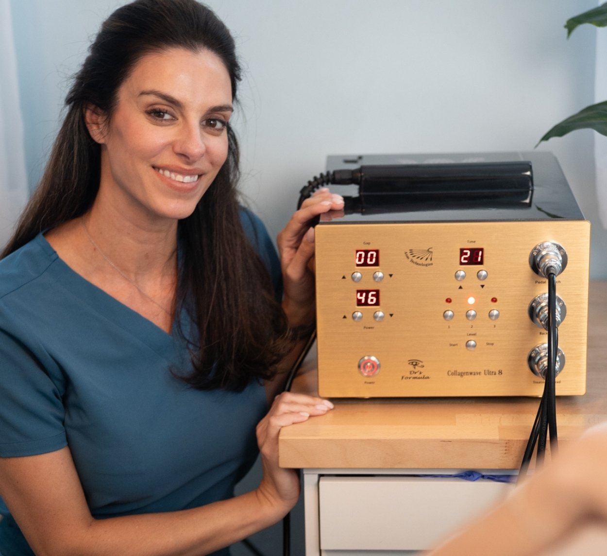 Rachel Lee Lozina holding their collagenwave device at Blue Water Spa. [49299c]