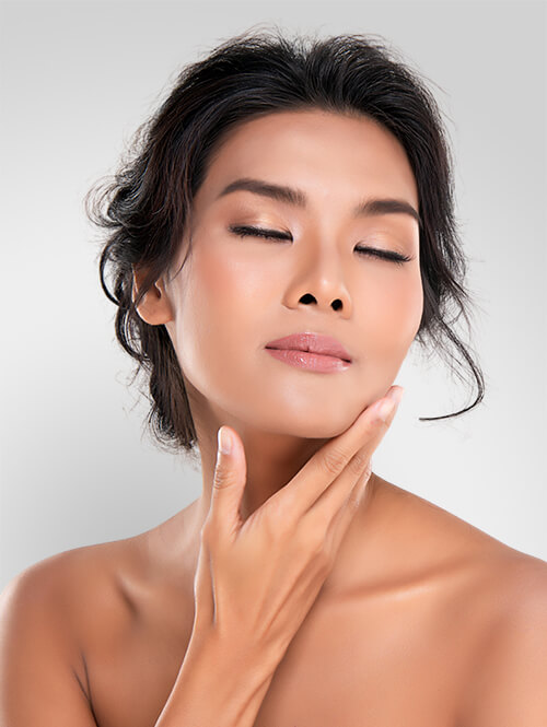 A woman touching her face showing her clear, bright, and tight skin. [7759ac]